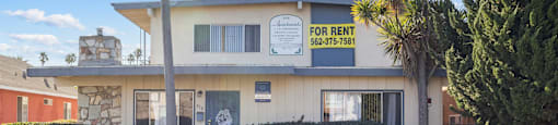 A house with a for rent sign on the front.
