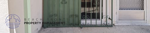 a door with a green gate and a window behind it