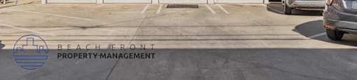 A white building with a sign that says Beach Front Property Management.