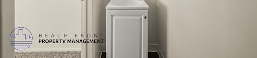 A small white bathroom with a sink and mirror.