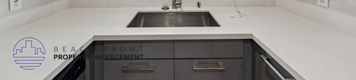 A kitchen with a sink and a window.
