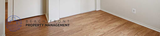 A room with a white wall and a wooden floor.