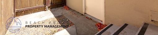 a backyard backdoor with a fence and a door to a house