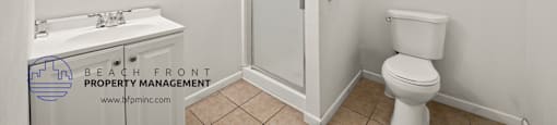 a small bathroom with a white sink and toilet and a white shower stall with a glass door