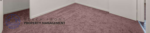 A room with a carpeted floor and a ceiling light.