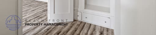 a renovated closet with white cabinets and white doors