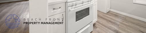 A white stove in a kitchen with a logo for Beach Front Property Management.