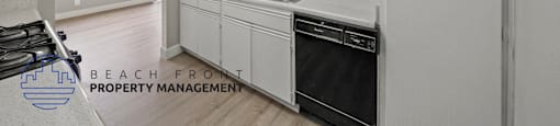 a white kitchen with white cabinets and a black dishwasher
