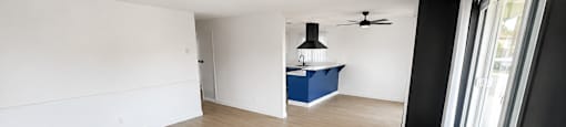 A room with a blue island in the middle of it.