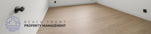 A room with a logo of Beach Front Property Management on the wall.