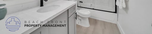 a white bathroom with a large mirror and a white toilet