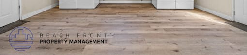 the beachfront property management logo and an image of a kitchen