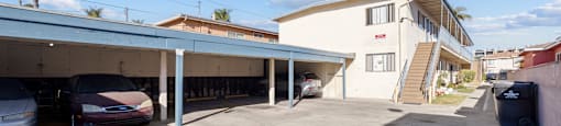 A parking garage with a car parked in front of it.
