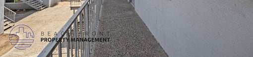 a long walkway leading up to a building with a balcony
