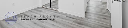 a renovated apartment with white walls and wood flooring and a hallway with white doors