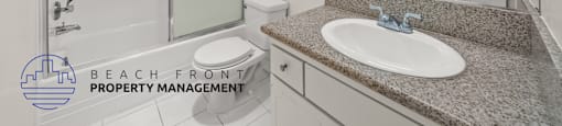 A bathroom with a sink, toilet, and shower.