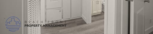 A hallway with a logo for Beach Front Property Management in the bottom left corner.