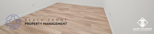 a white room with a wood floor and a ceiling fan