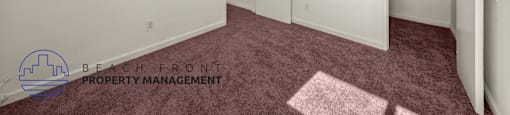 A room with a carpeted floor and white walls.