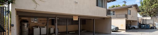 a garage in front of a building with a parking lot