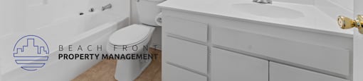 A bathroom with a white tub, sink, and mirror.