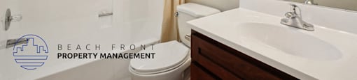 A bathroom with a toilet, sink, and mirror.