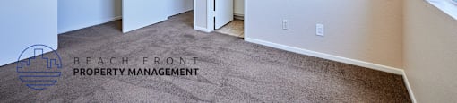 A room with a carpeted floor and a window on the right side.