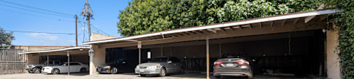 a parking lot with cars parked in front of a building