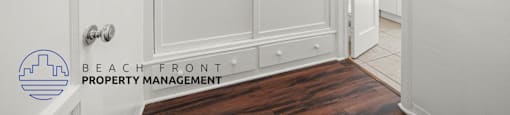 A white door with a handle and a logo that says Beach Front Property Management.