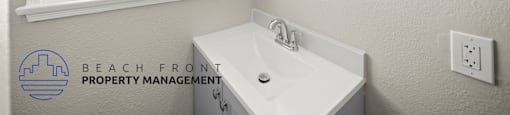 A bathroom with a large window and a white sink.