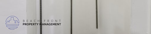 A metal rack with a logo of Beach Front Property Management.