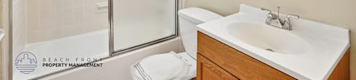 A bathroom with a sink, toilet, and shower.