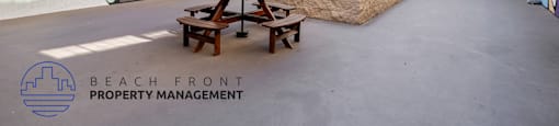 A courtyard with a picnic table and a mural on the wall.