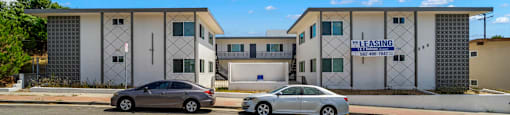 a building with two cars parked in front of it