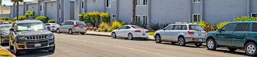 a city street with cars parked in front of a building