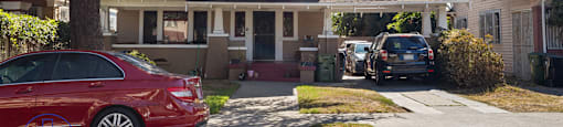 two cars parked in front of a house
