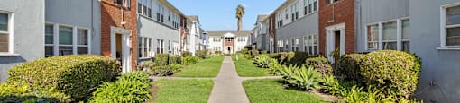 A row of houses with a pathway in the middle.