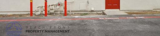 A house with a red door and a sign that says Beach Front Property Management.