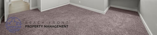 A room with a ceiling fan and a carpeted floor.