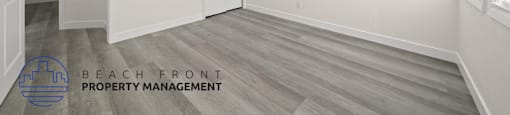 A room with a logo for Beach Front Property Management.
