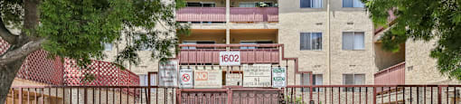 A gated entrance to a building with the sign "Front Property Management" in front.