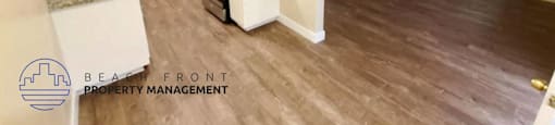 a renovated kitchen and living room with wood flooring
