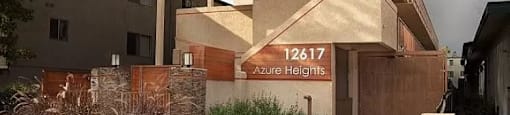 A modern building with the number 12617 Azure Heights on its signboard.