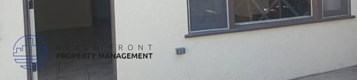 the side of a building with a window and a door