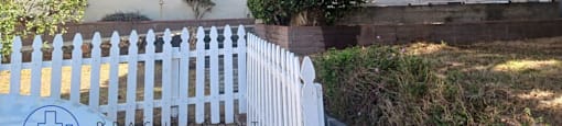 an old with a white picket fence