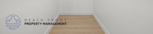 A white room with a logo for Beach Front Property Management on the wall.