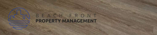 A room with a white door and a white closet with a logo of Beach Front Property Management.