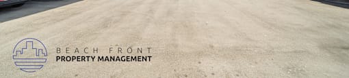 A parking lot with Beach Front Property Management logo.