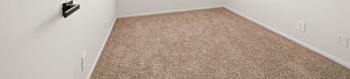 an empty room with carpet and a window