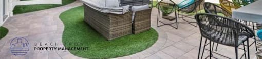 a patio area with a table and chairs and a couch